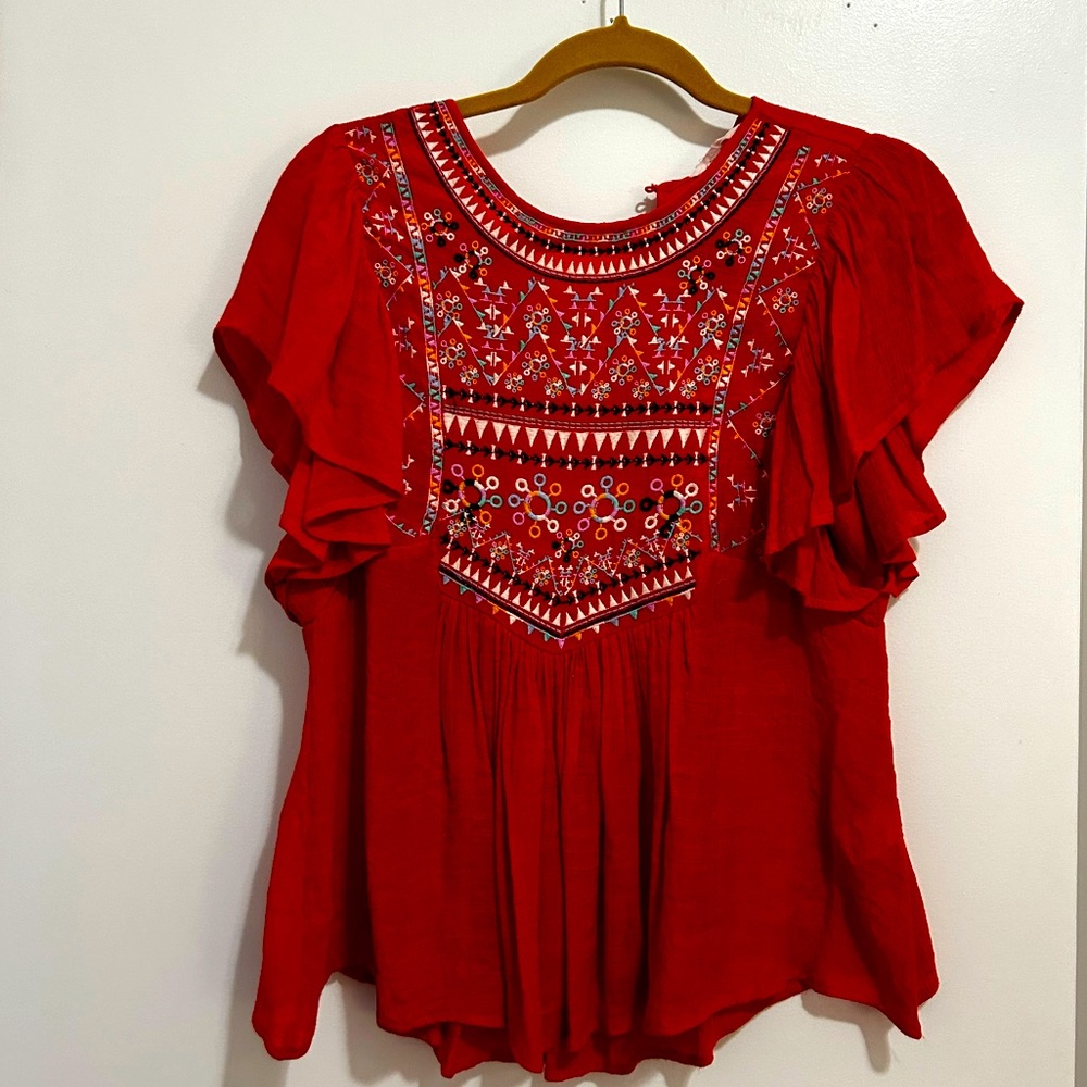 Red top with multicolor embroidered design